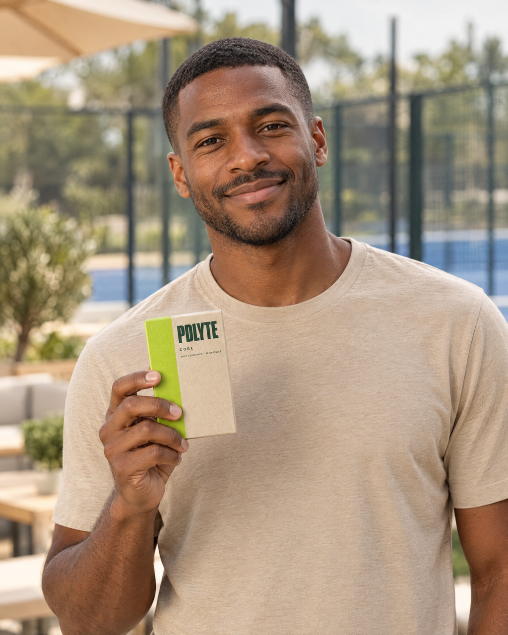 Padel player holding a PDLYTE CORE Daily Essentials box at the club